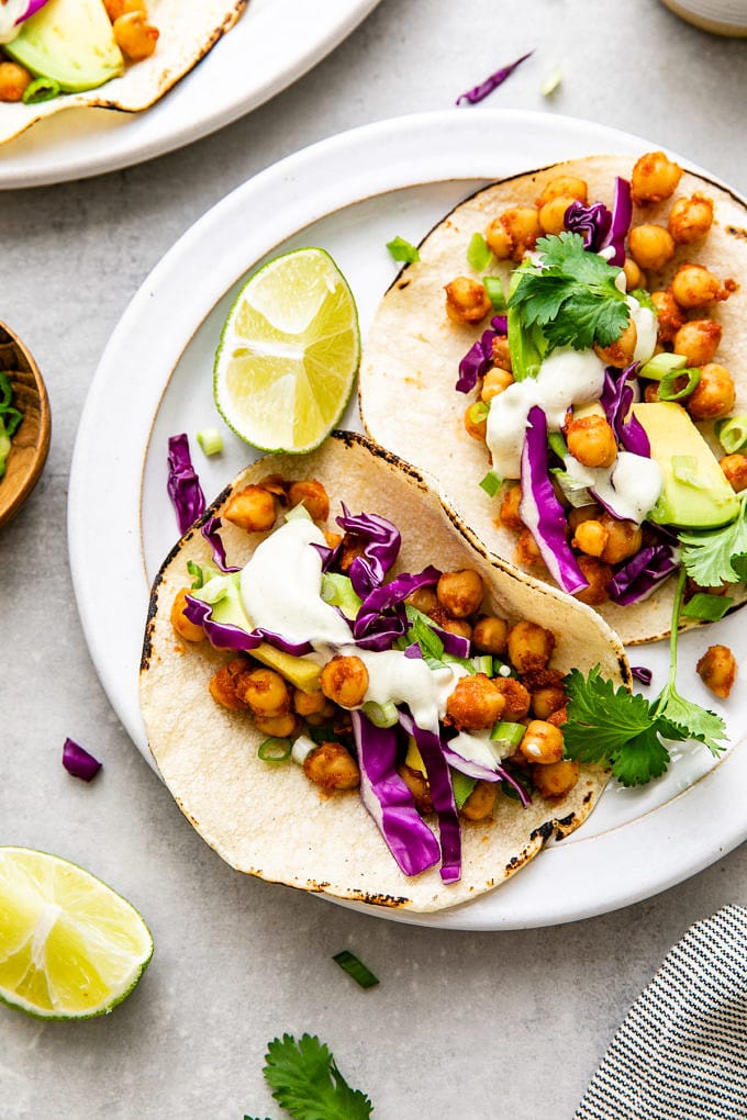 top down view of plate with chickpea tacos and items surrounding.