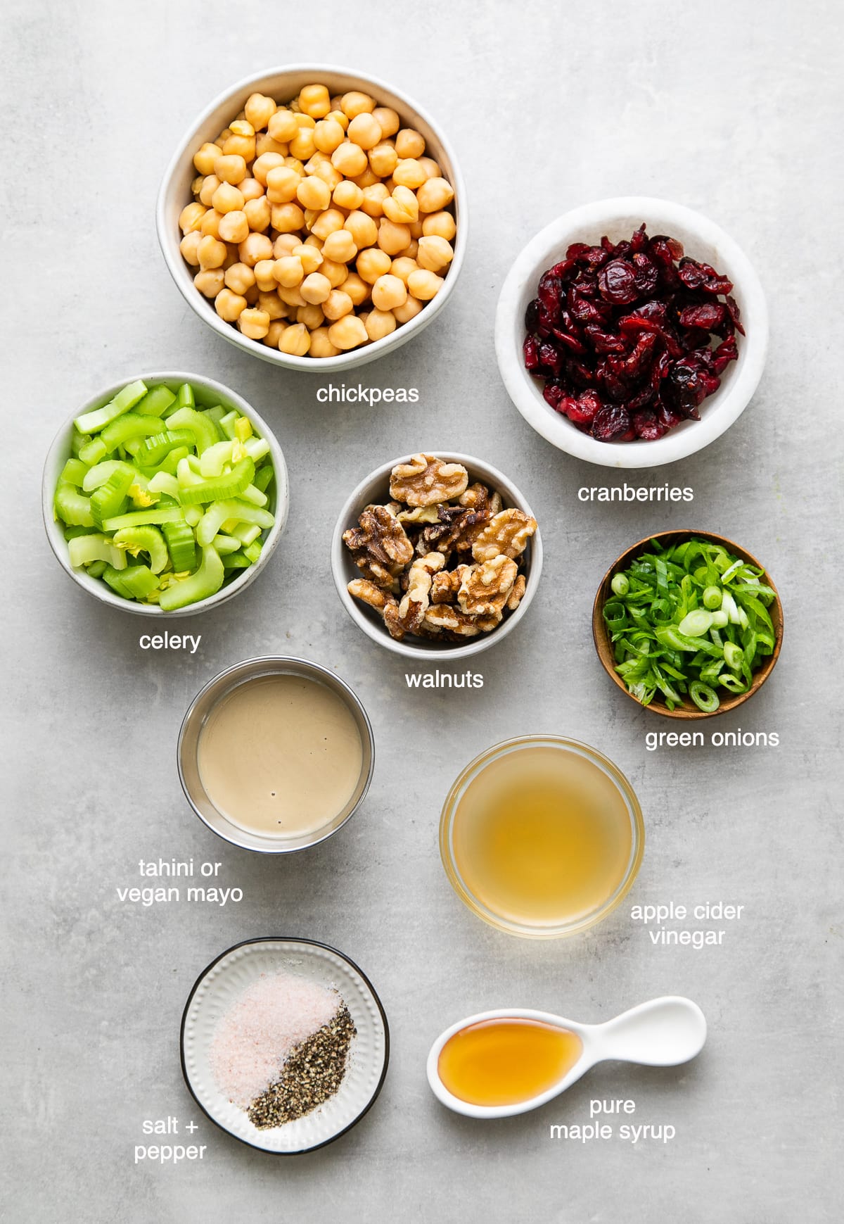 top down view of ingredients used to make the best vegan chicken salad with cranberries, chickpeas and walnuts.