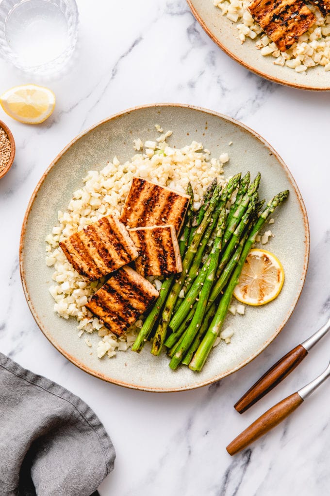 top down view of plated easy grilled tofu and asparagus with ginger cauliflower rice.