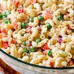 side angle view of vegan macaroni salad in a glass bowl.